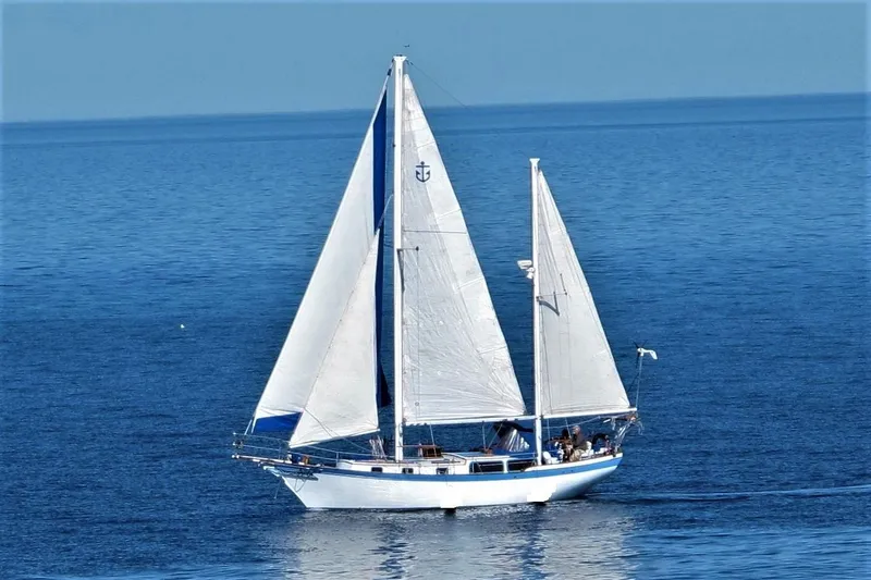 The Image of 1975 Downeast Ketch sailing on calm blue waters. - 0