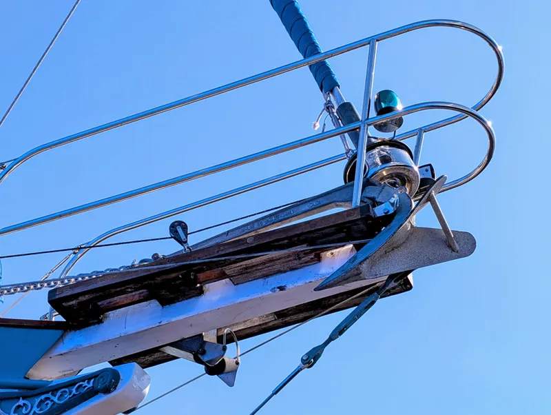Slide: The Image of Bow of 1975 Downeast Ketch sailboat with anchor against clear blue sky. - 10