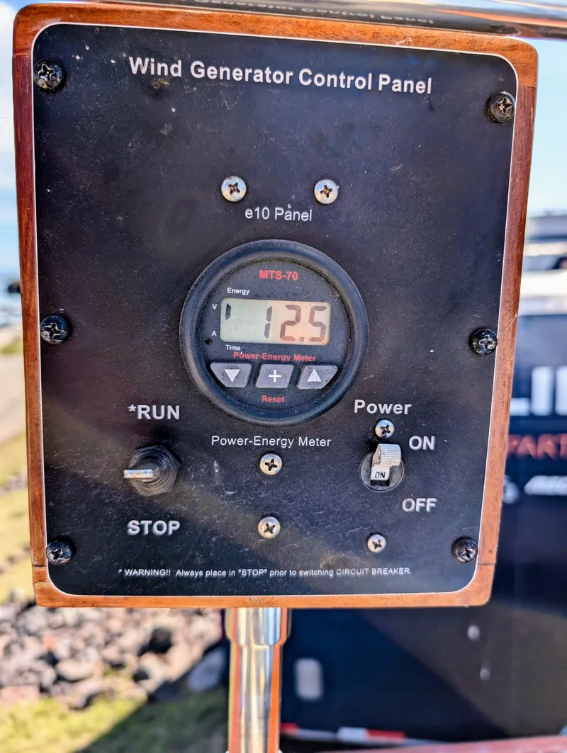 Slide: The Image of Wind generator control panel on 1975 Downeast Ketch, displaying power-energy meter reading. - 12