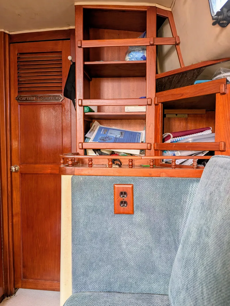 Slide: The Image of Interior of a 1975 Downeast Ketch with wooden shelves and nautical decor. - 28