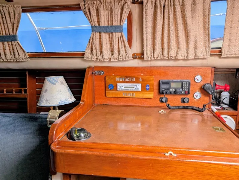 Slide: The Image of 1975 Downeast Ketch interior with navigation station, radio, and lamp. - 33