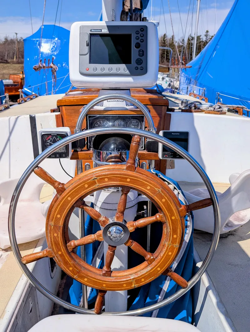 Slide: The Image of 1975 Downeast Ketch sailboat helm with wooden wheel and navigation equipment. - 4