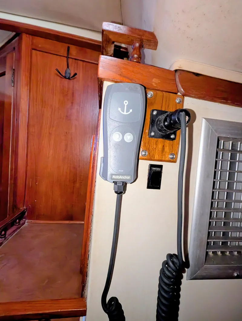 Slide: The Image of 1975 Downeast Ketch interior with mounted control panel and wooden cabinetry. - 40