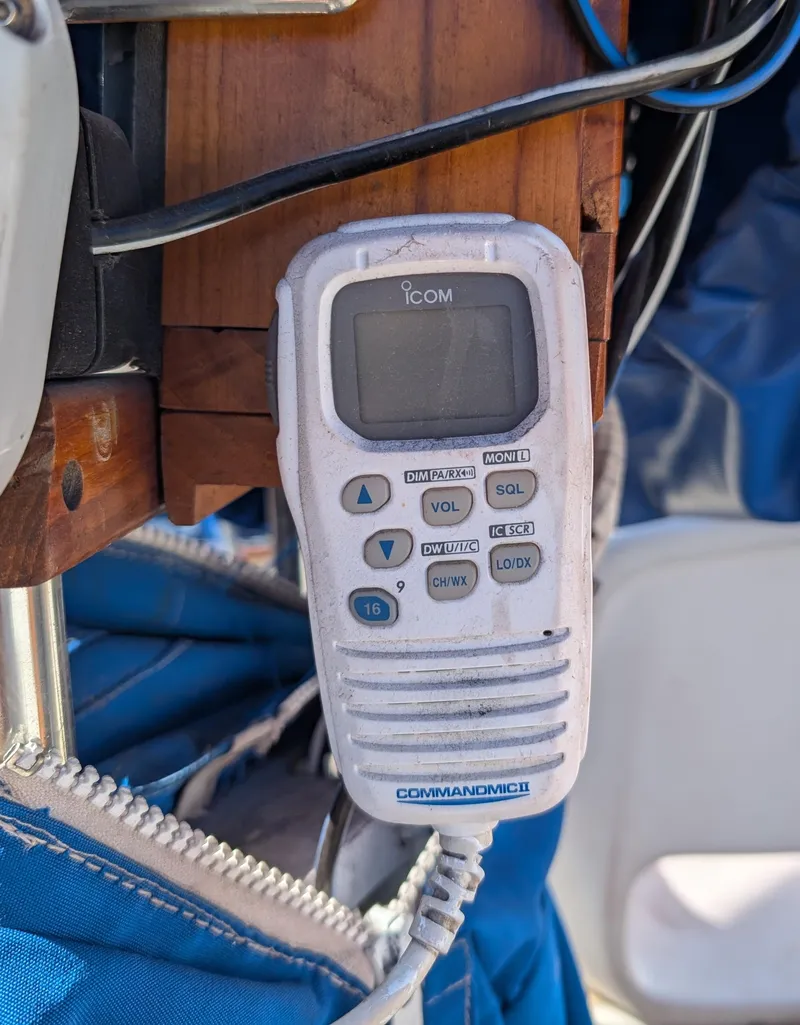 Slide: The Image of ICOM marine radio on 1975 Downeast Ketch sailboat, mounted near blue fabric. - 8
