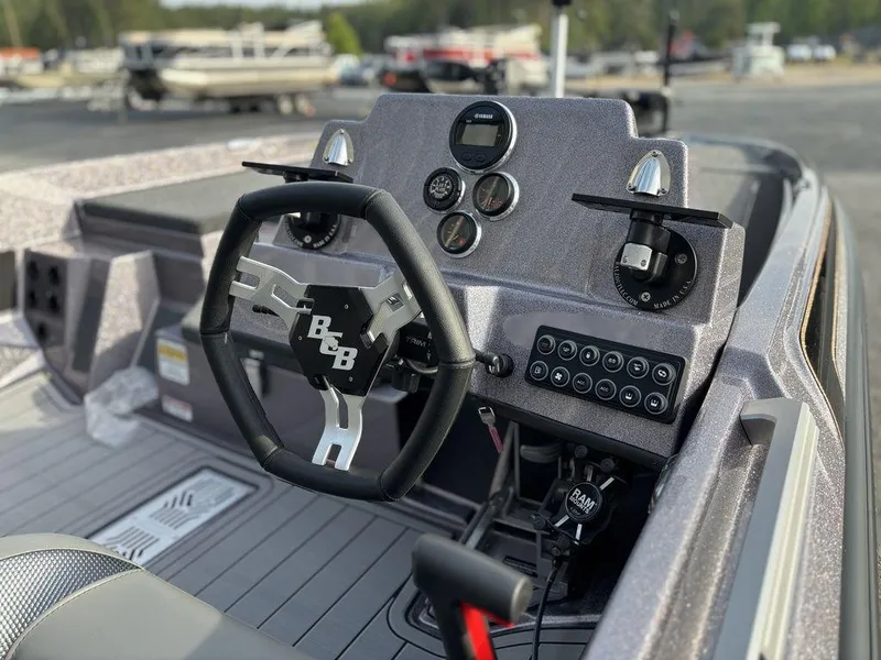 Slide: The Image of 2025 Bass Cat Puma STS boat dashboard with steering wheel and control panel. - 10