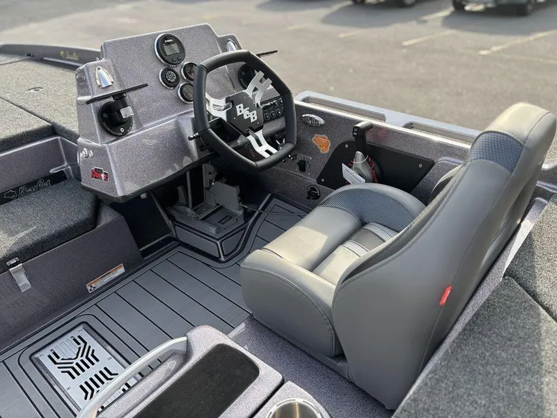 Slide: The Image of 2025 Bass Cat Puma STS boat interior with steering wheel and seat, showcasing modern design. - 12