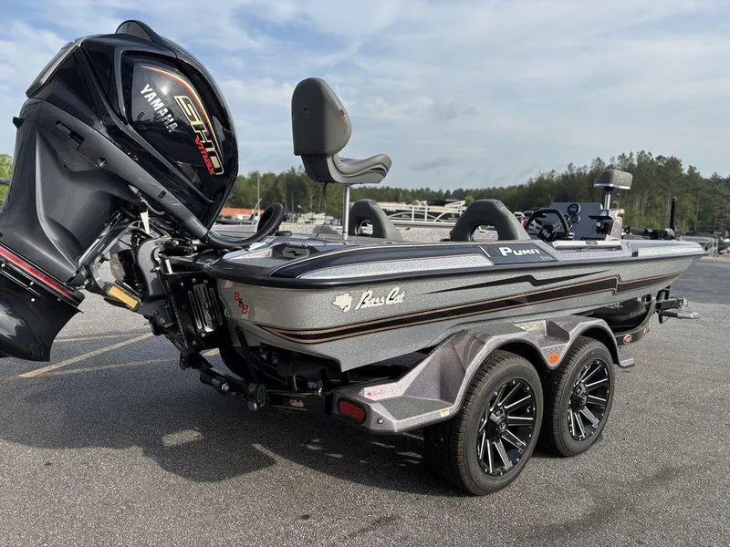 Slide: The Image of 2025 Bass Cat Puma STS boat with Yamaha engine, parked on a trailer. - 2