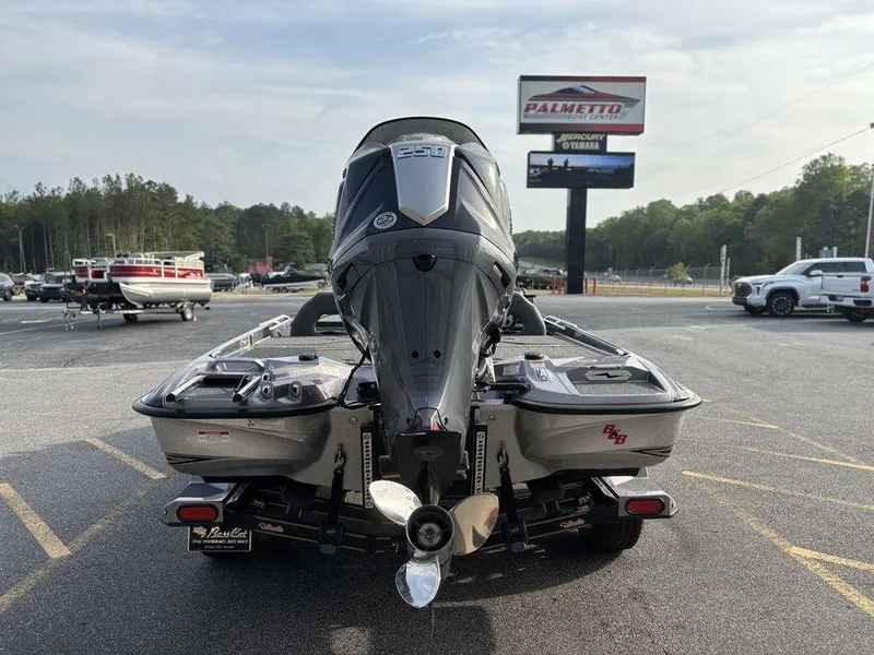 Slide: The Image of 2025 Bass Cat Puma STS boat with powerful outboard motor in a parking lot. - 4