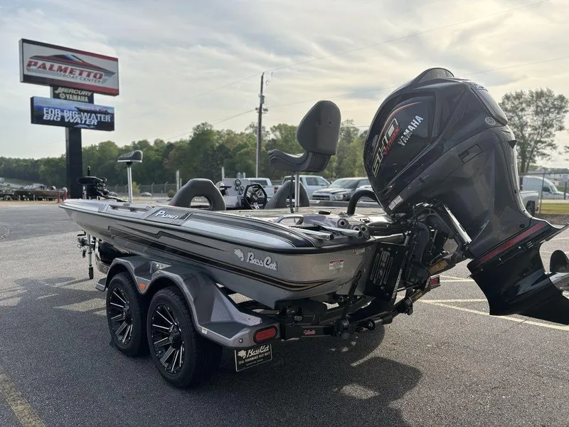 Slide: The Image of 2025 Bass Cat Puma STS boat with Yamaha engine in a parking lot. - 5