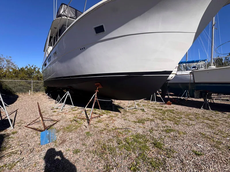 Slide: The Image of 1988 Chris-Craft 501 Motor Yacht on stands, side view, outdoors, sunny day. - 10