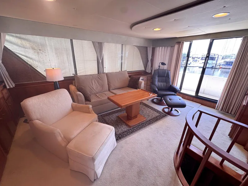 Slide: The Image of Luxurious interior of 1988 Chris-Craft 501 Motor Yacht with comfortable seating and large windows. - 12