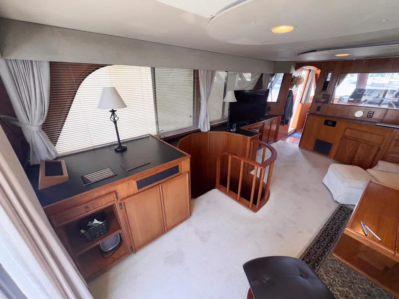 Slide: The Image of Interior of 1988 Chris-Craft 501 Motor Yacht with elegant wood furnishings and cozy seating area. - 17
