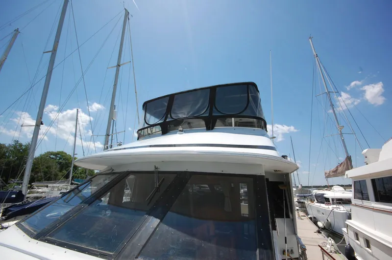 Slide: The Image of 1988 Chris-Craft 501 Motor Yacht docked under clear blue sky. - 2