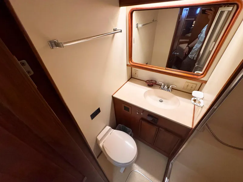 Slide: The Image of 1988 Chris-Craft 501 Motor Yacht bathroom with sink, mirror, and toilet. - 26