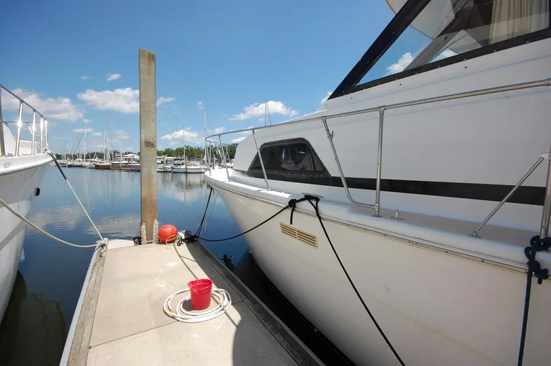 Slide: The Image of 1988 Chris-Craft 501 Motor Yacht docked at marina under clear blue sky. - 3
