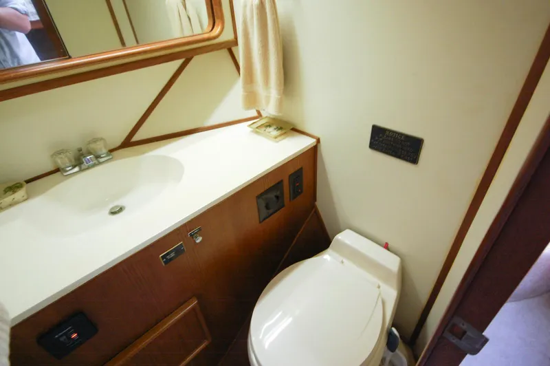 Slide: The Image of 1988 Chris-Craft 501 Motor Yacht bathroom with sink, mirror, and toilet. - 30