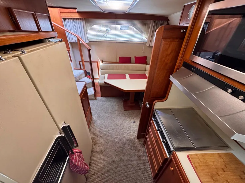 Slide: The Image of Interior of 1988 Chris-Craft 501 Motor Yacht with kitchen and seating area. - 39