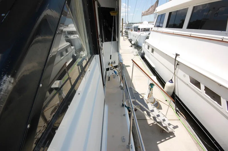 Slide: The Image of 1988 Chris-Craft 501 Motor Yacht docked alongside other boats in a marina. - 4