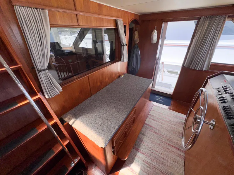 Slide: The Image of 1988 Chris-Craft 501 Motor Yacht interior with wood paneling, helm, and seating area. - 45