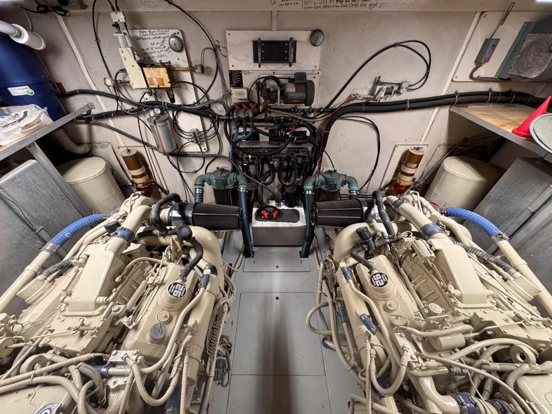 Slide: The Image of Engine room of a 1988 Chris-Craft 501 Motor Yacht, showcasing dual engines and wiring. - 47