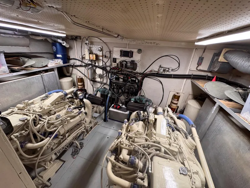 Slide: The Image of Engine room of 1988 Chris-Craft 501 Motor Yacht with dual engines and wiring. - 48
