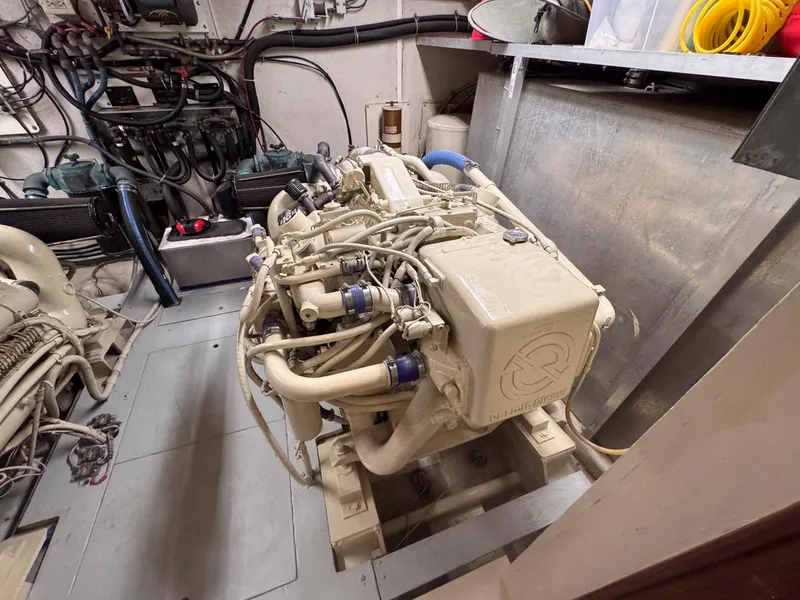 Slide: The Image of Engine room of 1988 Chris-Craft 501 Motor Yacht, showcasing detailed mechanical components. - 49