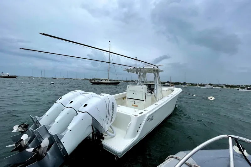 Slide: The Image of 2016 SeaVee 340Z boat with triple outboard engines on a cloudy day. - 0