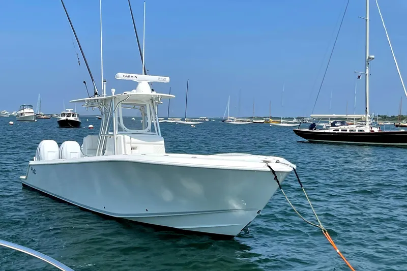 Slide: The Image of 2016 SeaVee 340Z boat anchored in a marina with clear blue skies. - 1