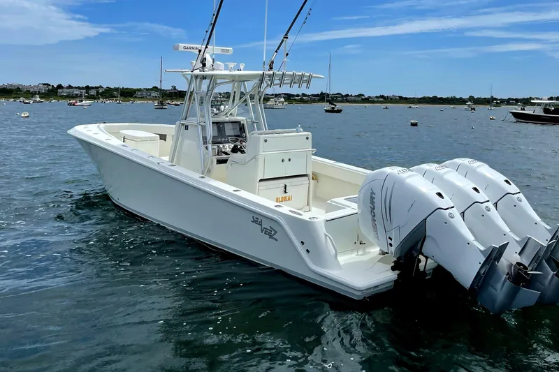 Slide: The Image of 2016 SeaVee 340Z boat with triple engines on calm water. - 2