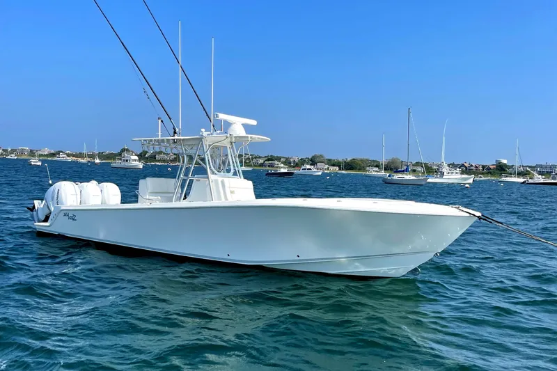 Slide: The Image of 2016 SeaVee 340Z boat on water, clear sky, other boats in background. - 3