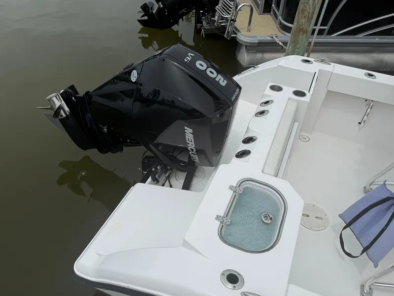 Slide: The Image of 2024 Aquasport 2200 Center Console boat with powerful 200 HP outboard motor. - 10