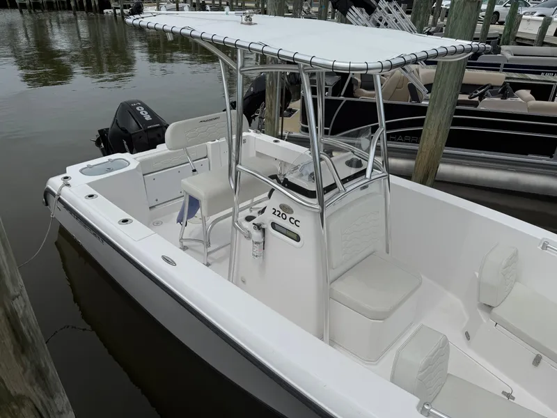 Slide: The Image of 2024 Aquasport 2200 Center Console boat docked, featuring sleek design and spacious seating. - 3