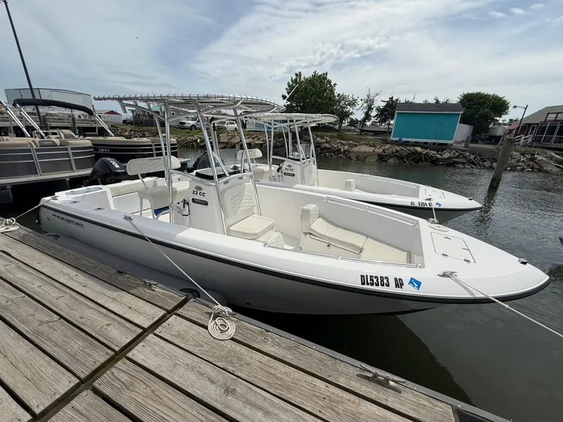 Slide: The Image of 2024 Aquasport 2200 Center Console boat docked at a marina. - 3