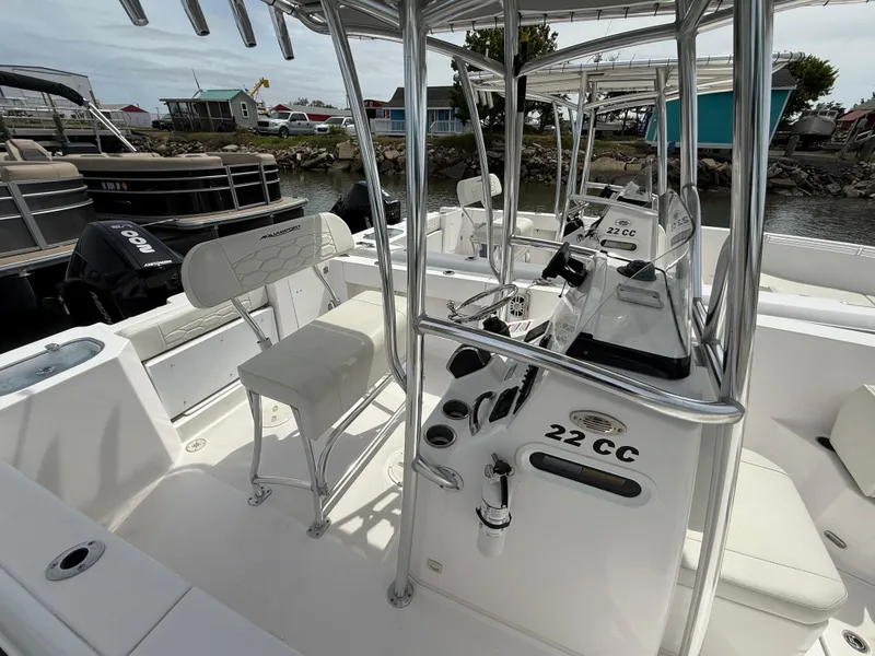 Slide: The Image of 2024 Aquasport 2200 Center Console boat interior with seating and controls. - 6