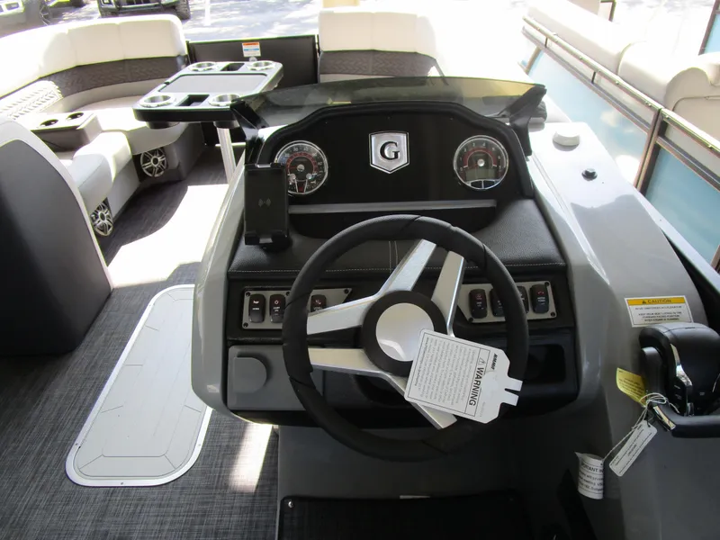 Slide: The Image of 2025 Monaco Cruise 235 C boat interior with steering wheel and seating area. - 11