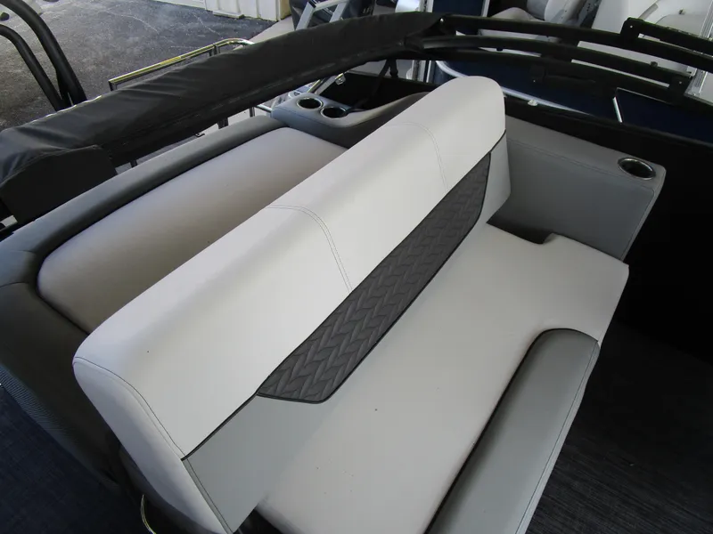 Slide: The Image of 2025 Monaco Cruise 235 C boat interior with stylish seating and cup holders. - 12