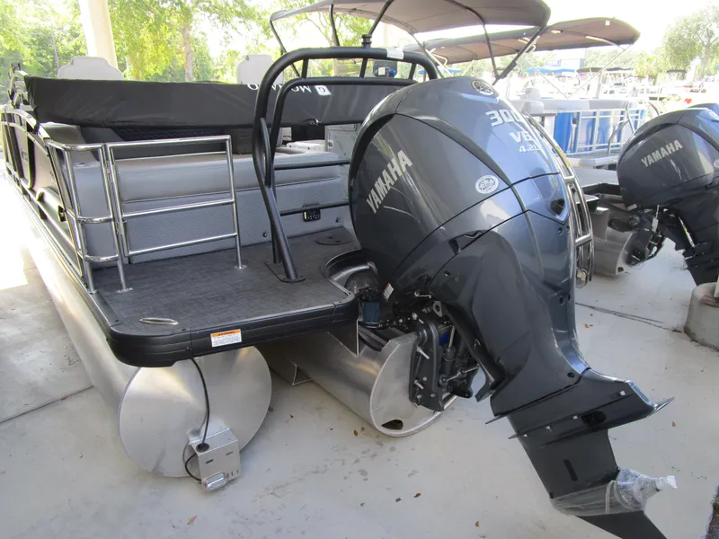 Slide: The Image of 2025 Monaco Cruise 235 C pontoon boat with Yamaha outboard motor, docked outdoors. - 5