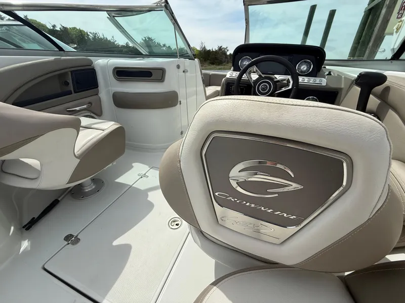 Slide: The Image of 2023 Crownline Eclipse E235 XS boat interior with steering wheel and seating. - 10