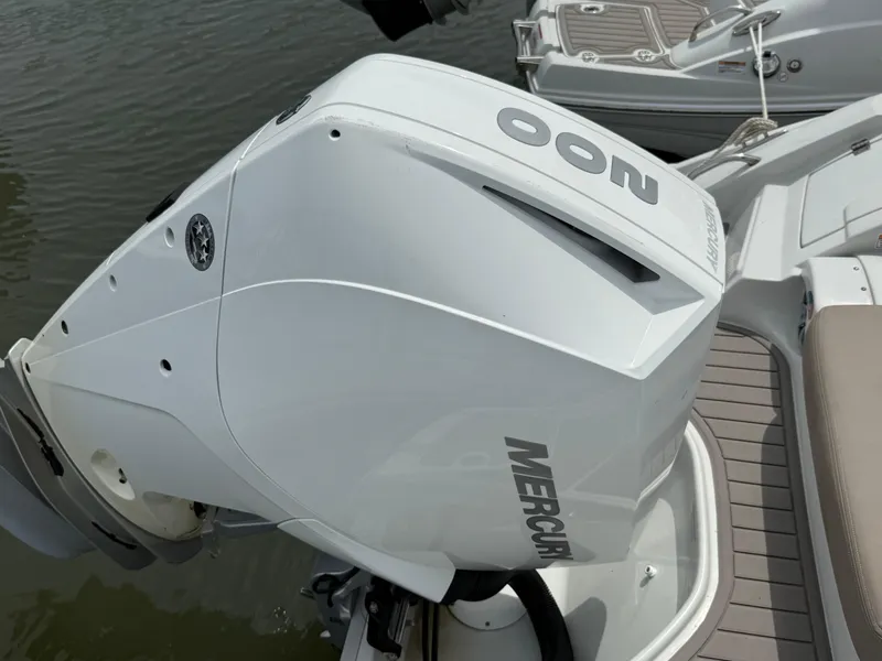Slide: The Image of Outboard motor on 2023 Crownline Eclipse E235 XS boat, docked on water. - 3