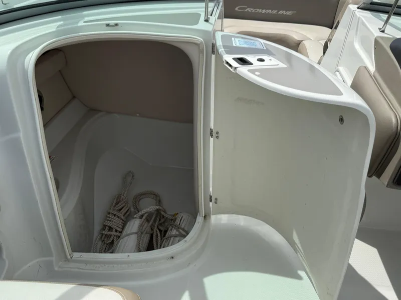 Slide: The Image of 2023 Crownline Eclipse E235 XS boat storage compartment with ropes inside. - 4