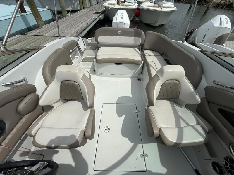 Slide: The Image of 2023 Crownline Eclipse E235 XS boat interior with beige seating and spacious layout. - 7