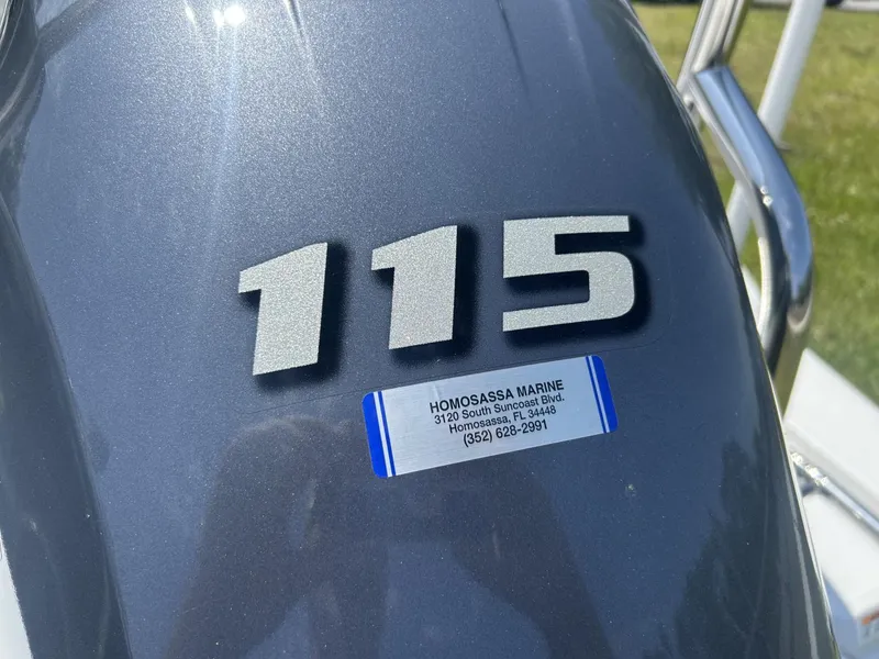 Slide: The Image of 2021 Hurricane SunDeck Sport 185 OB engine cover with "115" and Homosassa Marine contact label. - 4
