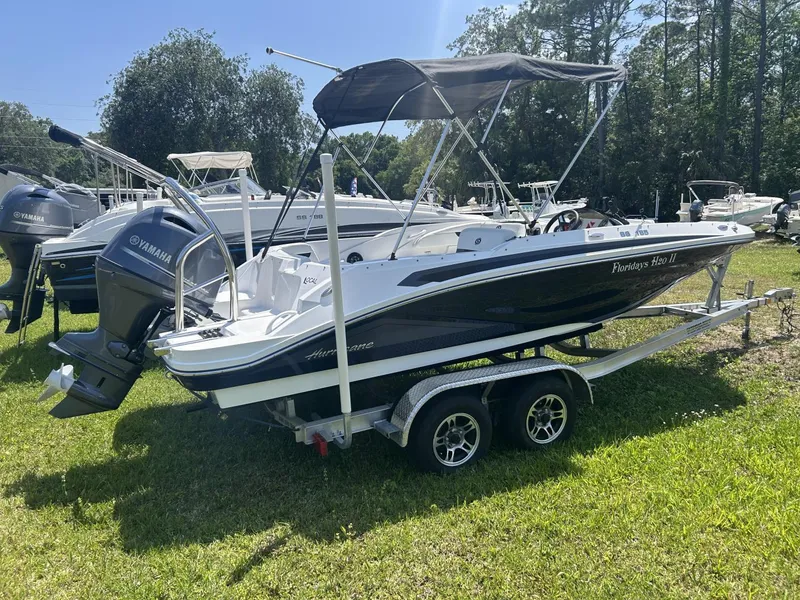 Slide: The Image of 2021 Hurricane SunDeck Sport 185 OB boat on trailer, featuring Yamaha outboard motor. - 7