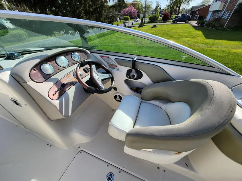 Slide: The Image of 2006 Sea Ray 240 Sundeck boat interior with steering wheel and dashboard. - 11