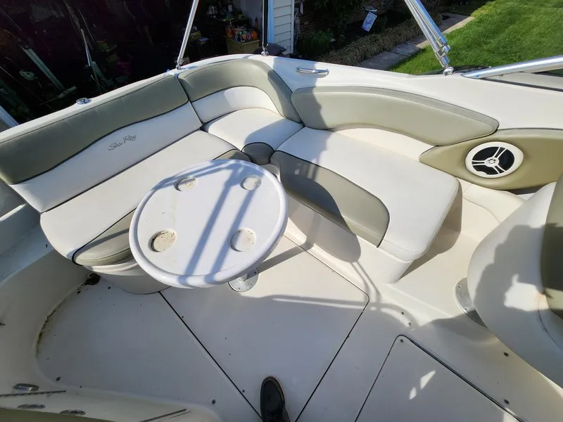 Slide: The Image of 2006 Sea Ray 240 Sundeck interior with seating and round table. - 14