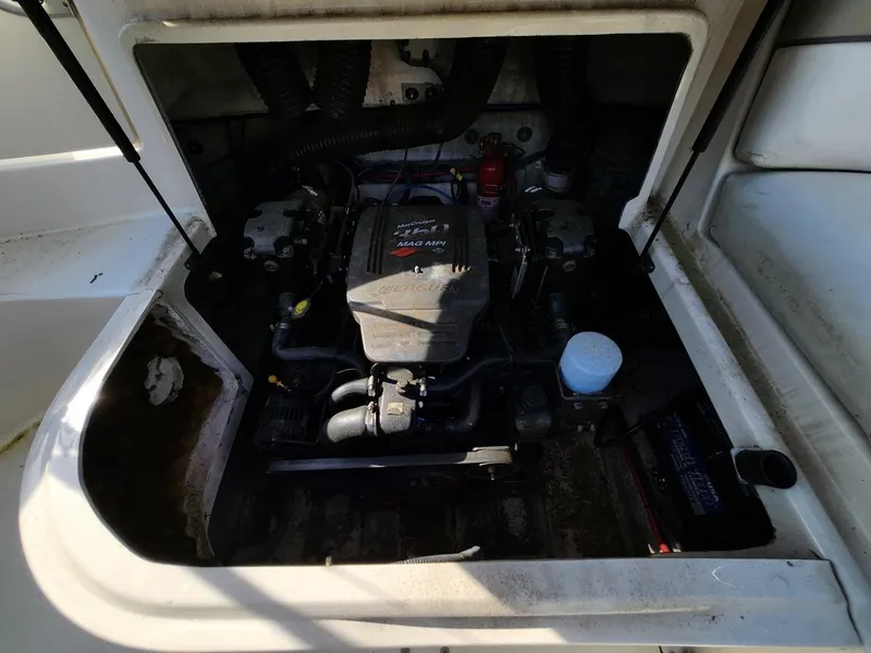 Slide: The Image of Engine compartment of a 2006 Sea Ray 240 Sundeck boat, showcasing the motor and components. - 16