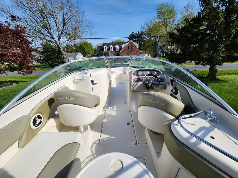 Slide: The Image of 2006 Sea Ray 240 Sundeck boat interior with steering wheel, seats, and dashboard. - 8
