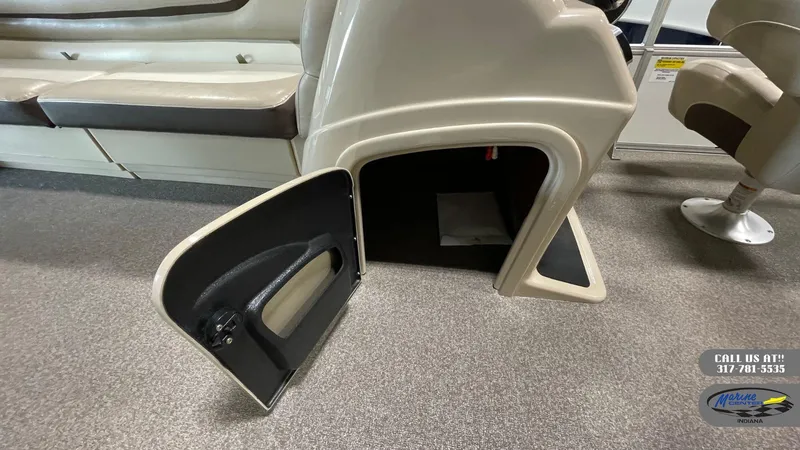 Slide: The Image of 2016 Sun Tracker Party Barge 22 DLX interior storage compartment with open door. - 10