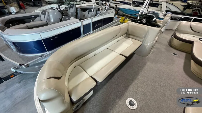 Slide: The Image of 2016 Sun Tracker Party Barge 22 DLX with beige seating in a showroom. - 12