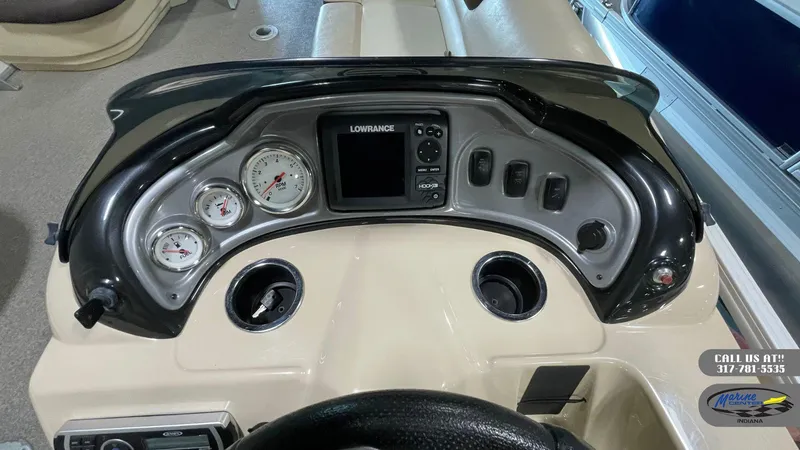 Slide: The Image of Dashboard of a 2016 Sun Tracker Party Barge 22 DLX with gauges and Lowrance display. - 14